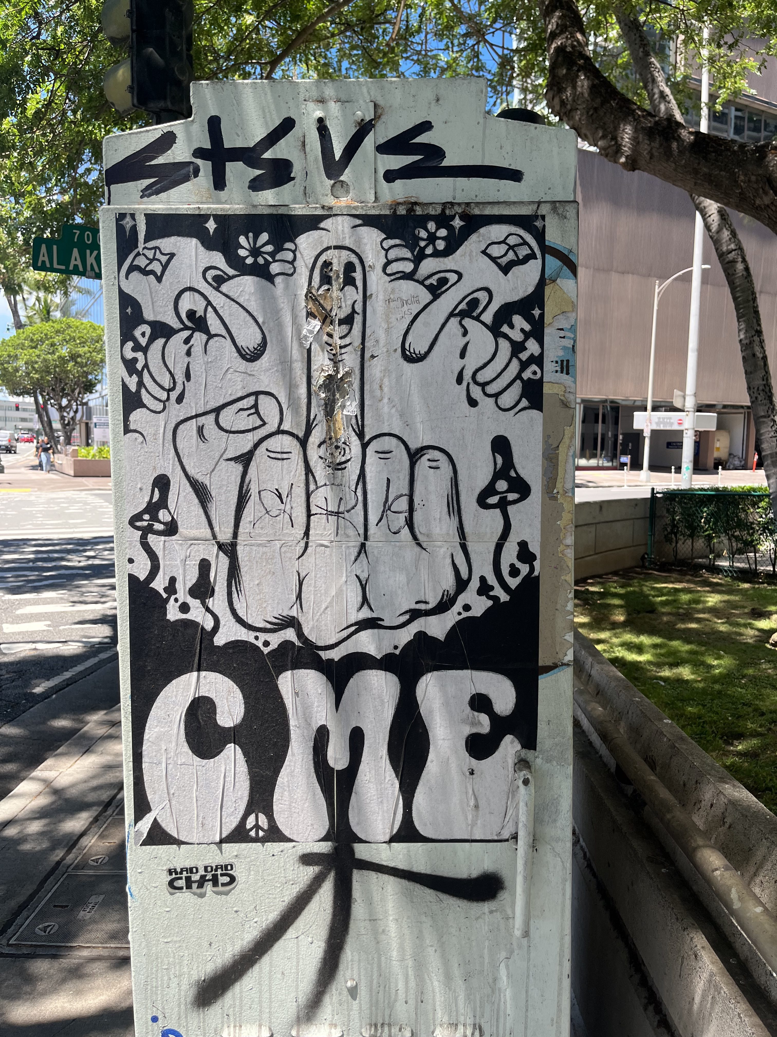 A street art piece on a utility box featuring a hand with the middle finger raised, surrounded by decorative elements. The word 'CME' is prominently displayed below the hand, with additional graffiti and tags present.